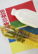Sunflower-seed oil and milk on a background the small flags of Ukraine and Byelorussia