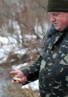 A man holds dead fish