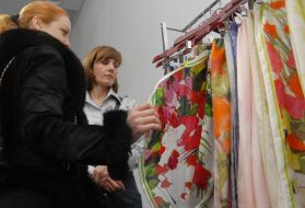 A girl examines scarfs