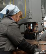 The convict works on a sewing machine