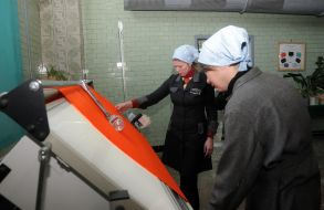 The convicts works on a sewing machine