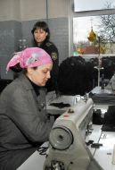 The convict works on a sewing machine