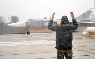 Runway controller regulates the motion of airplane SU-24M