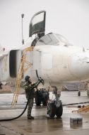 Serviceman near the airplane SU-24M