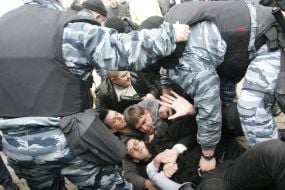 Militia employees detain the participants of action