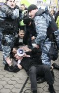Militia employees detain the participants of action