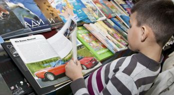 The boy examines a book 