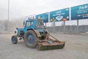 Tractor cleans the asphalt