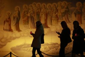 Believings carries a lighted candle home