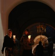 Believings carries a lighted candle home