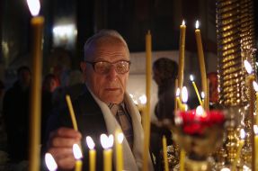 The believer puts a candle