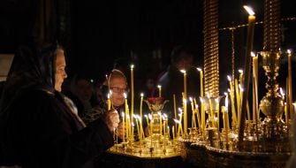 The believer puts a candle