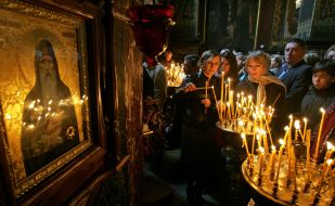 The believer puts a candle