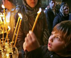 The believer puts a candle