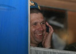 Peacemaker is talking on a cell phone