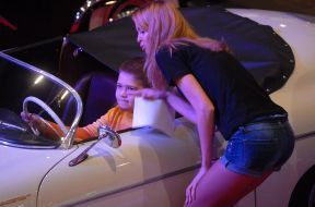 Boy after the helm of retro-car