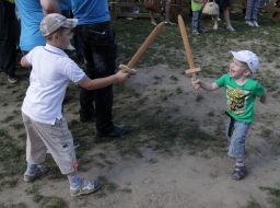 The children are fighting with wooden swords