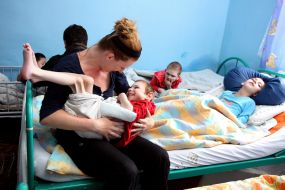 Volunteer with boy-invalid