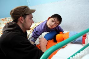 Volunteer with boy-invalid