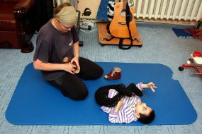 Volunteer with boy-invalid