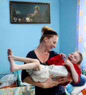 Volunteer with boy-invalid