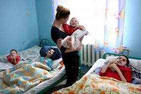 Volunteer with boy-invalid