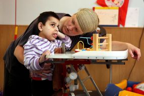 Volunteer with boy-invalid