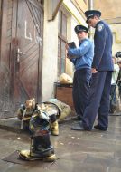 AMilitiamen stand near the head of Stalin