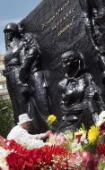 A woman lays flowers to the monument «Victory»