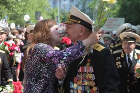 The woman kisses a veteran of Great Patriotic war