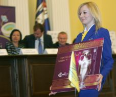 A girl carries the megascopic image of postage stamp