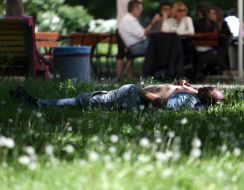 A drunken man lying on the grass