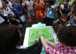 The cake as the soccer field is cut 