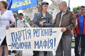 Участники акции протеста держат плакат