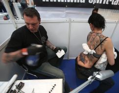 The man does tattoo