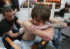 The man does tattoo