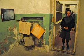 A woman stands near the entrance to the museum