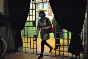 A woman stands near the entrance to the museum