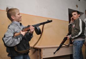 Children playes by firearms