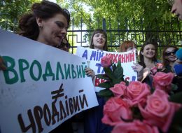 The girls hold placards