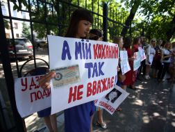 The girls hold placards