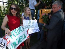 The girls hold placards
