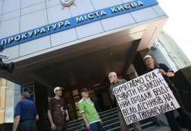 The participants of action hold placard