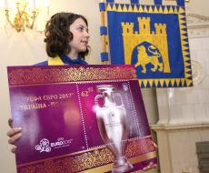 A girl holds the megascopic image of postage stamp