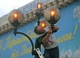 An employee changes the light bulb on the flashlight