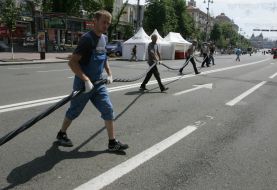 Workers stretch an electric power cable