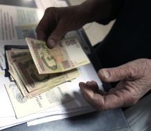 Elderly woman counts a money
