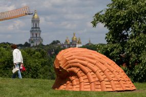 People near the sculpture