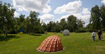 People near the sculpture