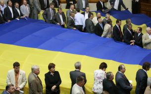 People's deputies near the enormous flag of Ukraine 